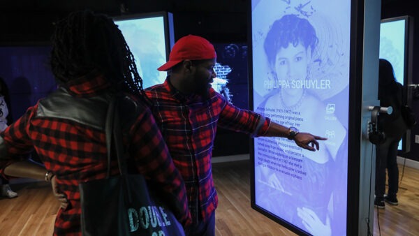Visitors interacting with touch screen displays