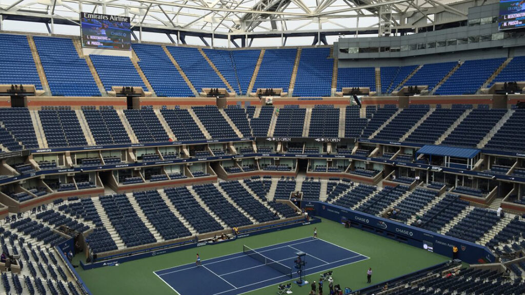 Tennis court with the roof partially retracted at the Arthur Ashe Stadium